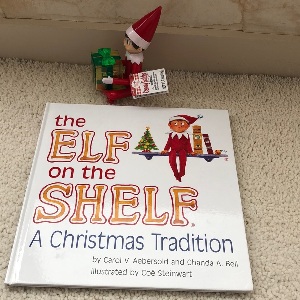 Elf on the Shelf hardcover book and candy holding elf